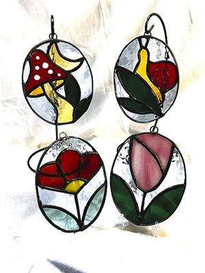 stained glass ovals of flowers, snails, mushrooms