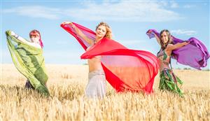 belly dancers in a field