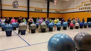 people performing ball drumming