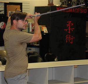 man posing with longsword