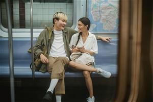 young couple sitting on subway