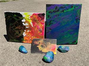 multiple canvases of acyrlic pour