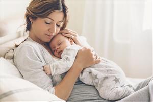 mother holding sleeping baby