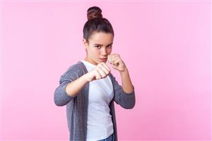 girl putting up hand for self defense