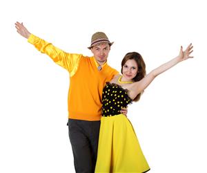 dance couple in yellow outfits posing