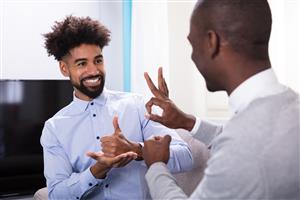 two men communicating through sign language