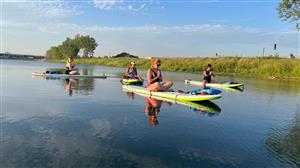 women doing yoga on paddleboards